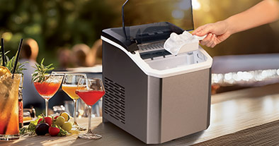 machine à glaçon posée sur une table avec des verres cocktails